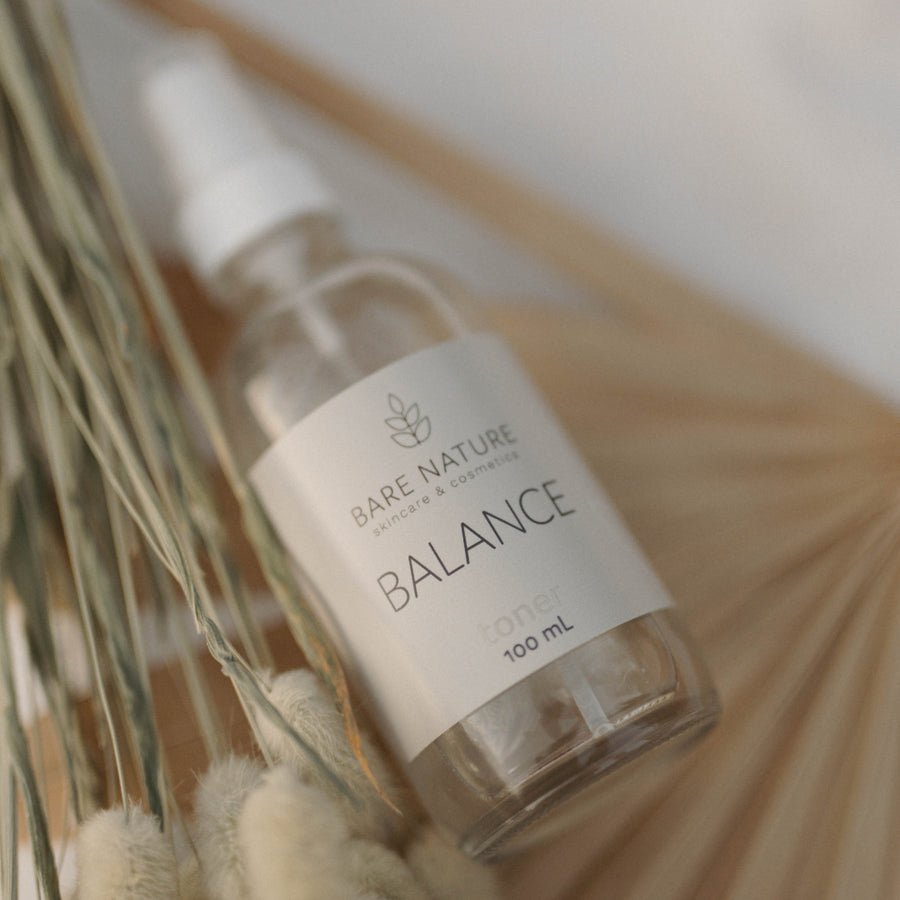A 100 mL clear glass spray bottle of Bare Nature Balance Toner with a white pump and a pale pink label, set against a plain white background.