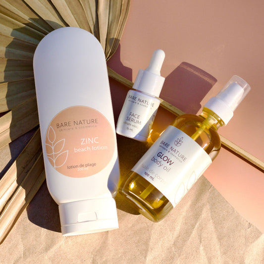 Bare Nature skincare products including a lotion, serum, and body oil on a textured surface.